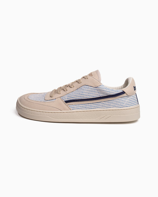 Beige barefoot sneaker with blue pattern on a white background